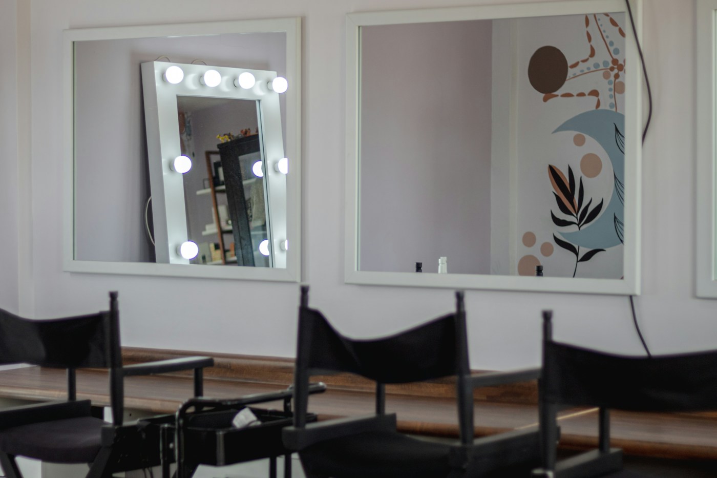 A salon station with a chair, mirror and hair products — representative stock photograph
